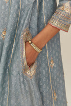 Powder blue hand block printed short kalidar silk chanderi kurta set with button placket and all over gold gota and zari embroidery.