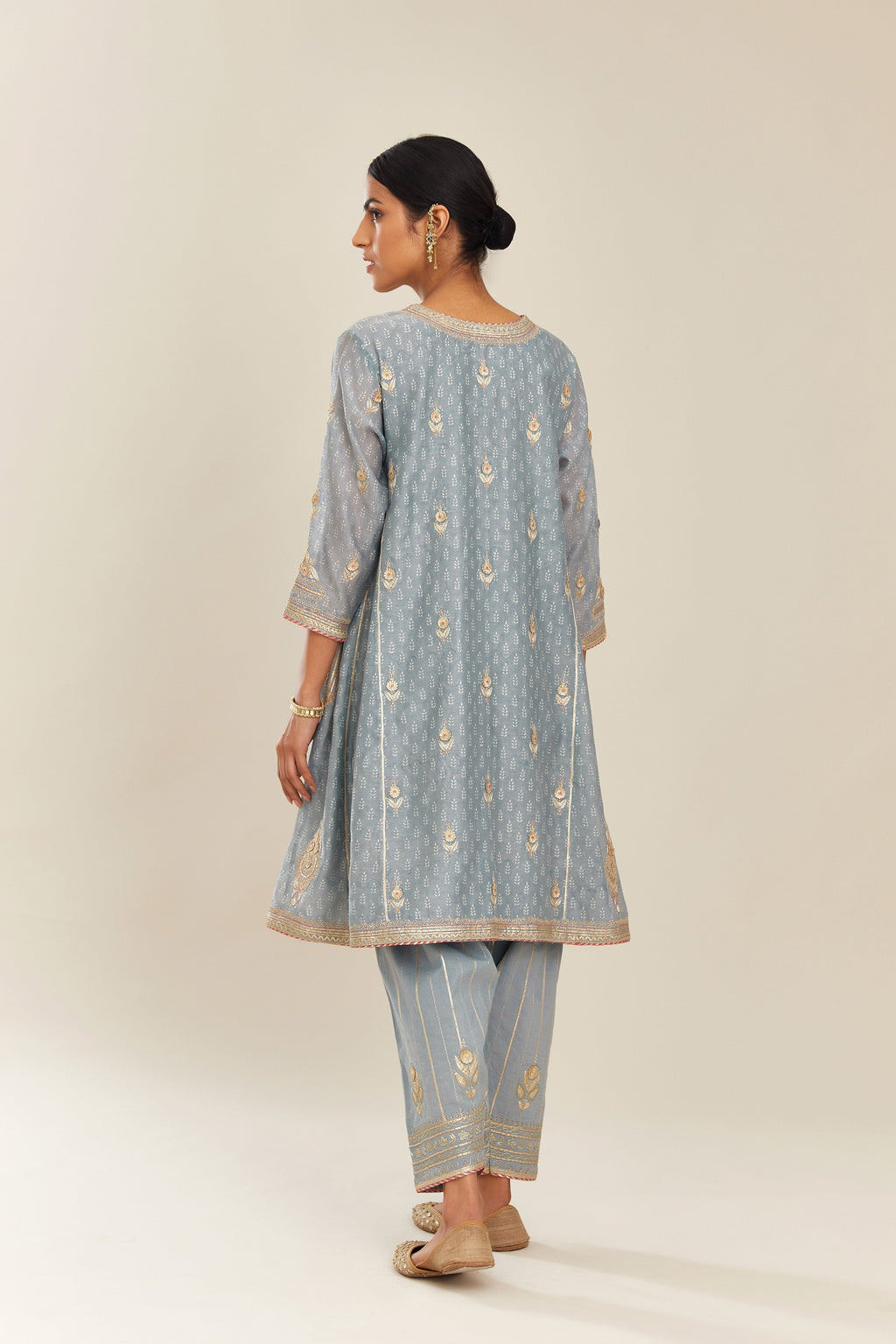 Powder blue hand block printed short kalidar silk chanderi kurta set with button placket and all over gold gota and zari embroidery.