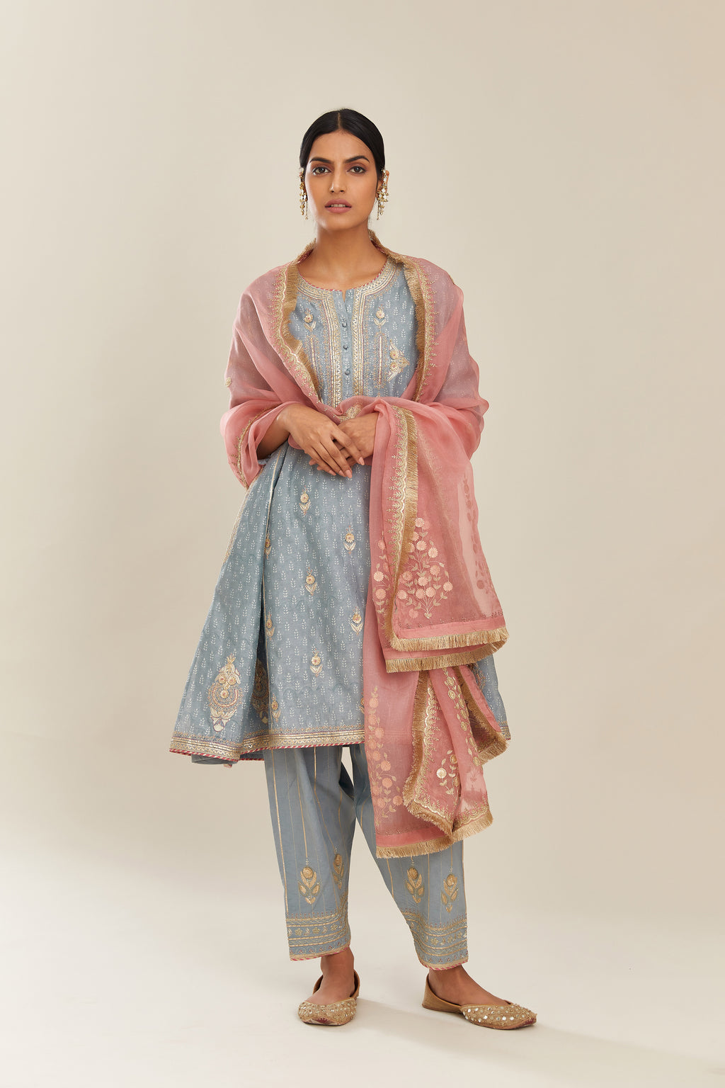 Powder blue hand block printed short kalidar silk chanderi kurta set with button placket and all over gold gota and zari embroidery.