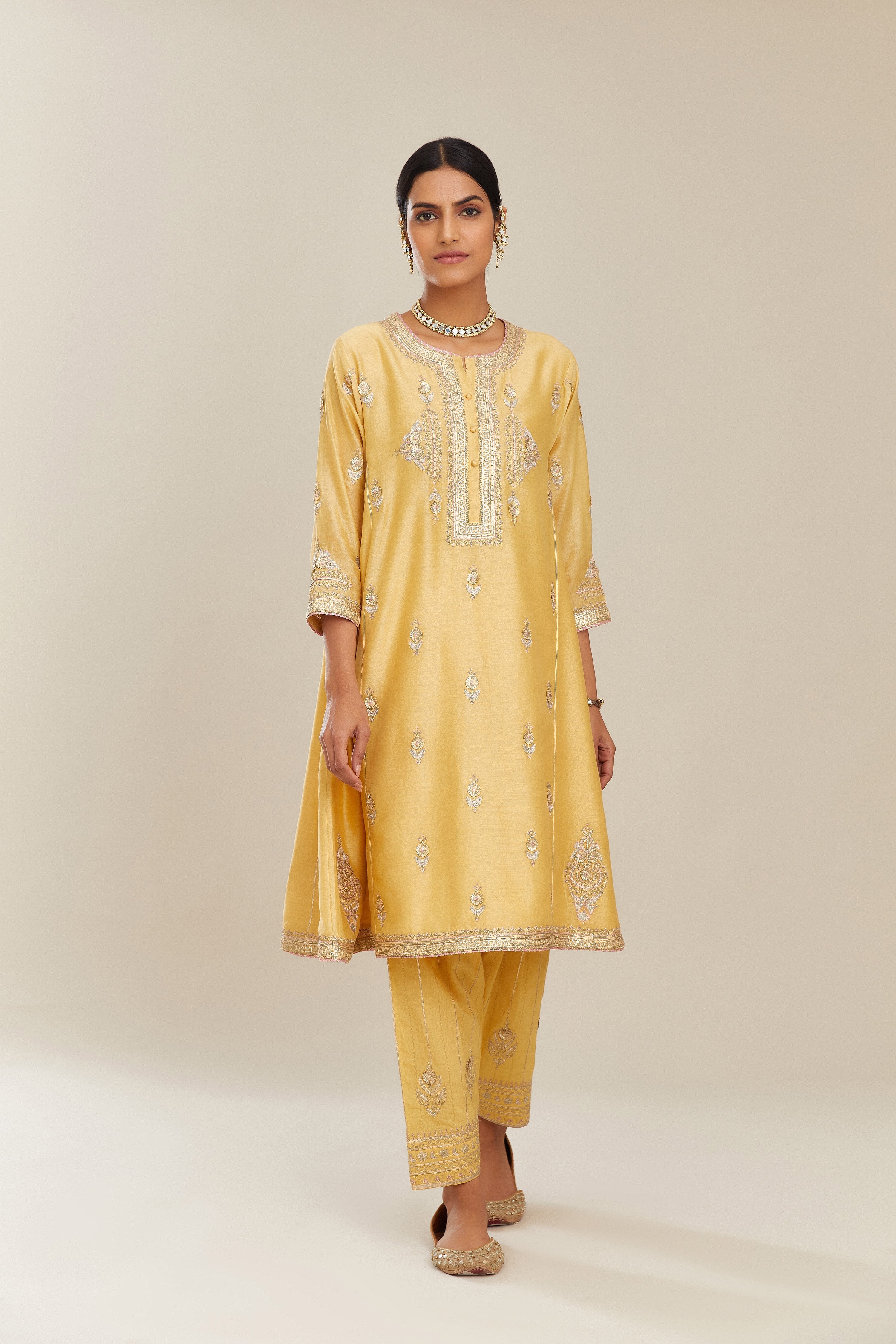 Yellow short kalidar silk chanderi kurta set with button placket and all over gold gota and zari embroidery.