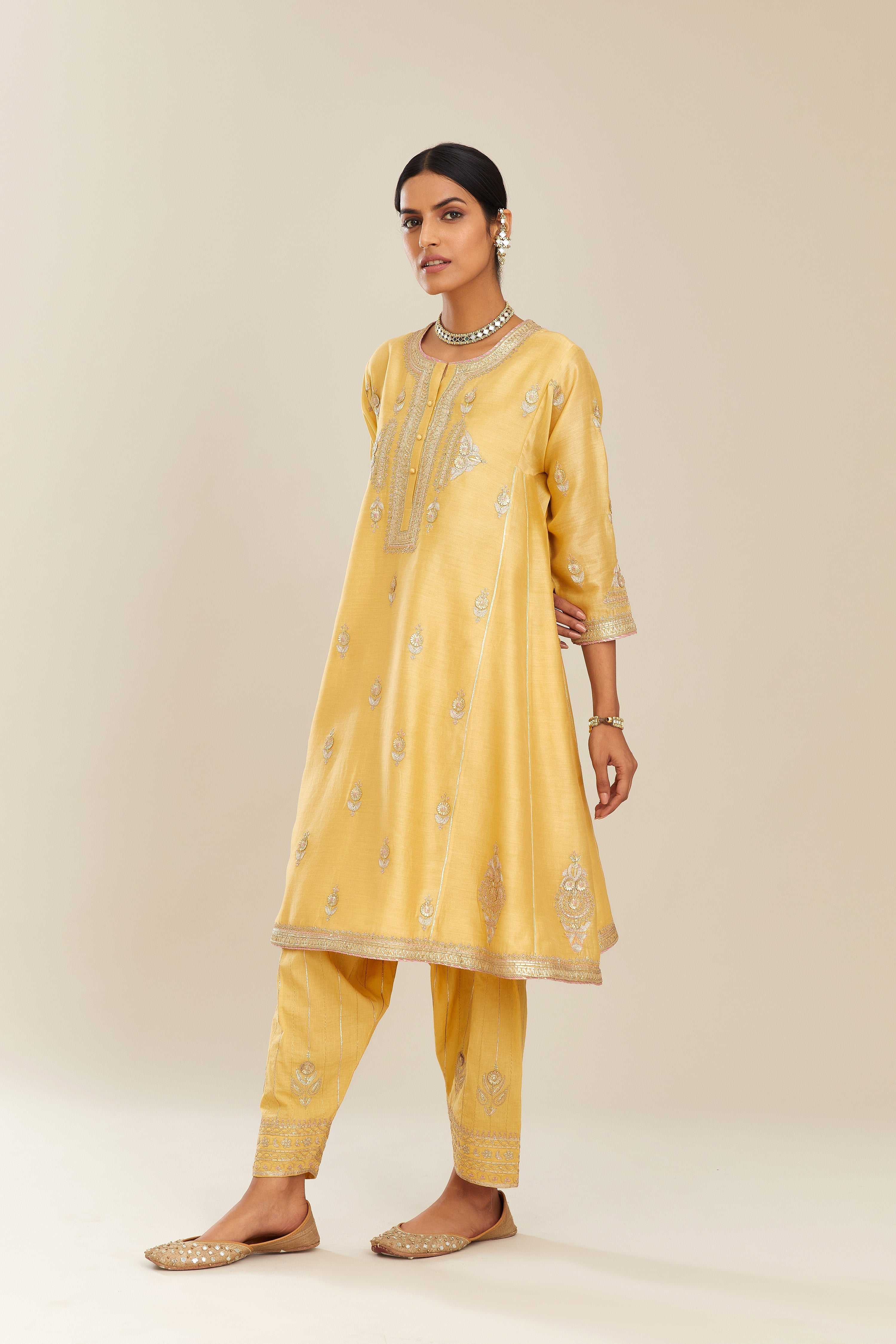Yellow short kalidar silk chanderi kurta set with button placket and all over gold gota and zari embroidery.