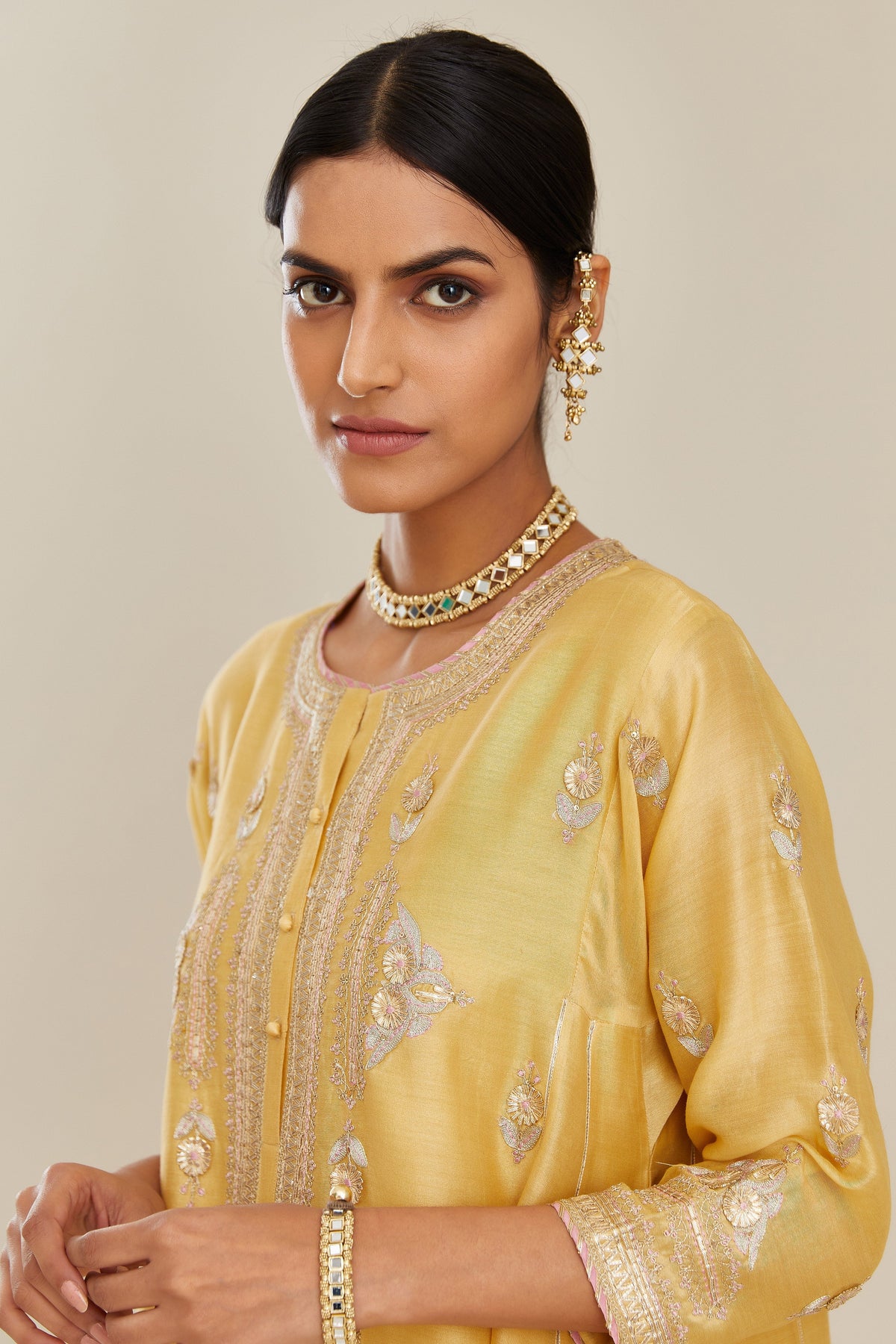Yellow short kalidar silk chanderi kurta set with button placket and all over gold gota and zari embroidery.