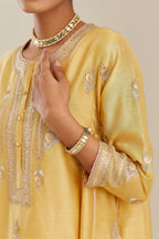 Yellow short kalidar silk chanderi kurta set with button placket and all over gold gota and zari embroidery.