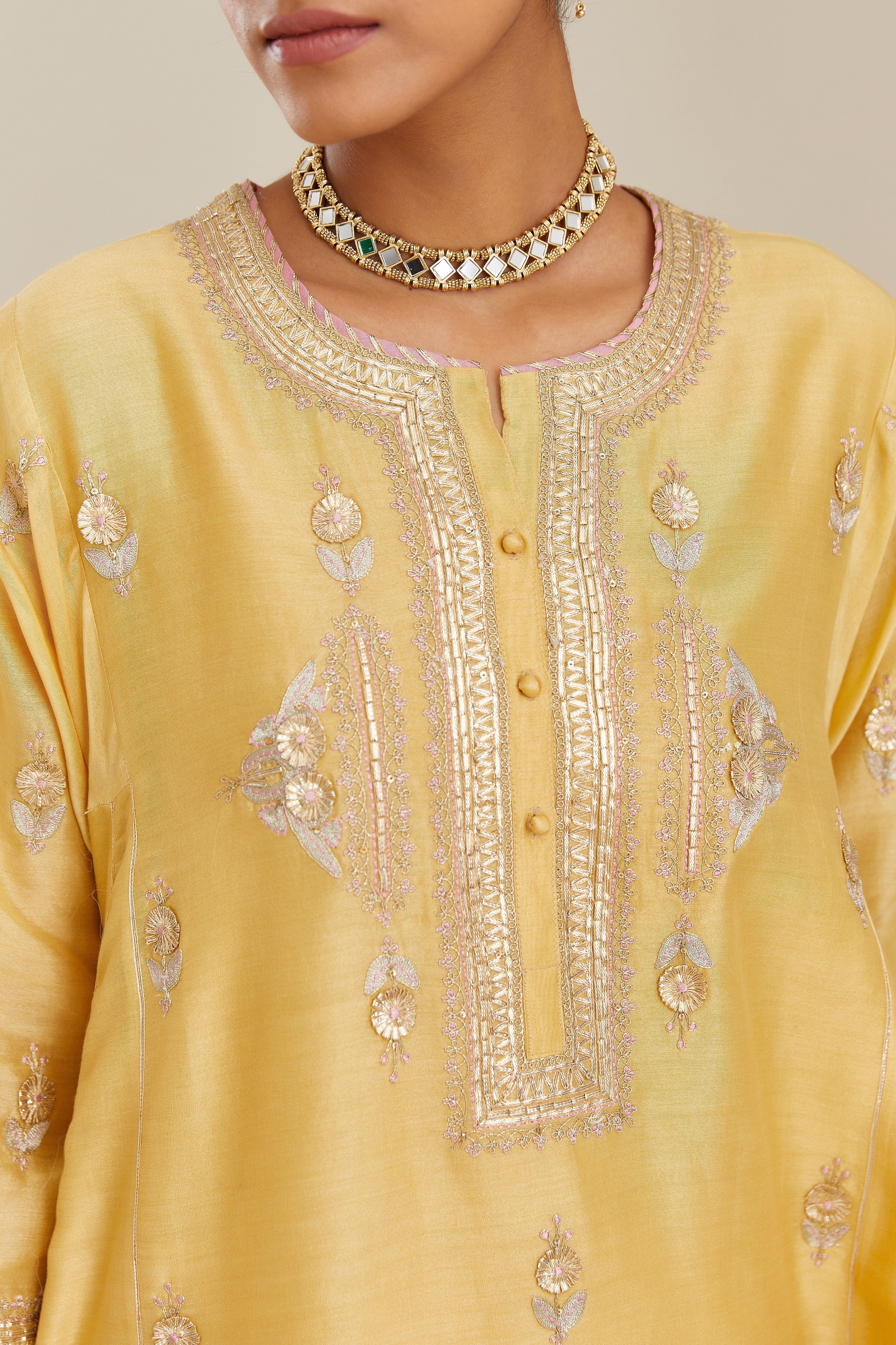 Yellow short kalidar silk chanderi kurta set with button placket and all over gold gota and zari embroidery.