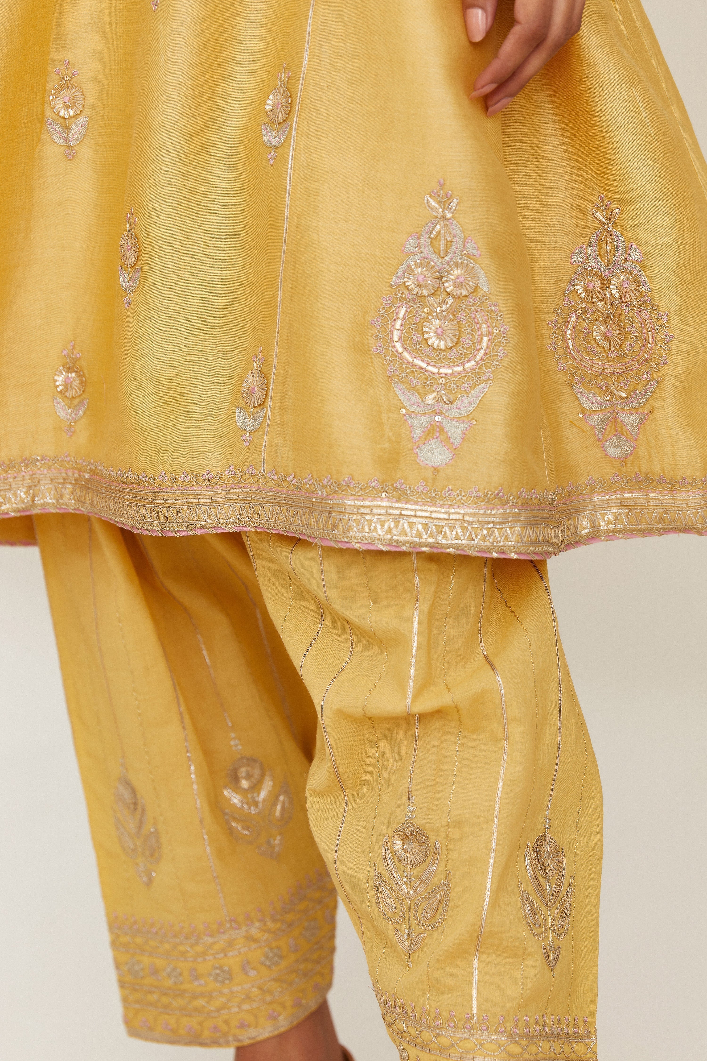 Yellow short kalidar silk chanderi kurta set with button placket and all over gold gota and zari embroidery.