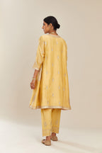 Yellow short kalidar silk chanderi kurta set with button placket and all over gold gota and zari embroidery.