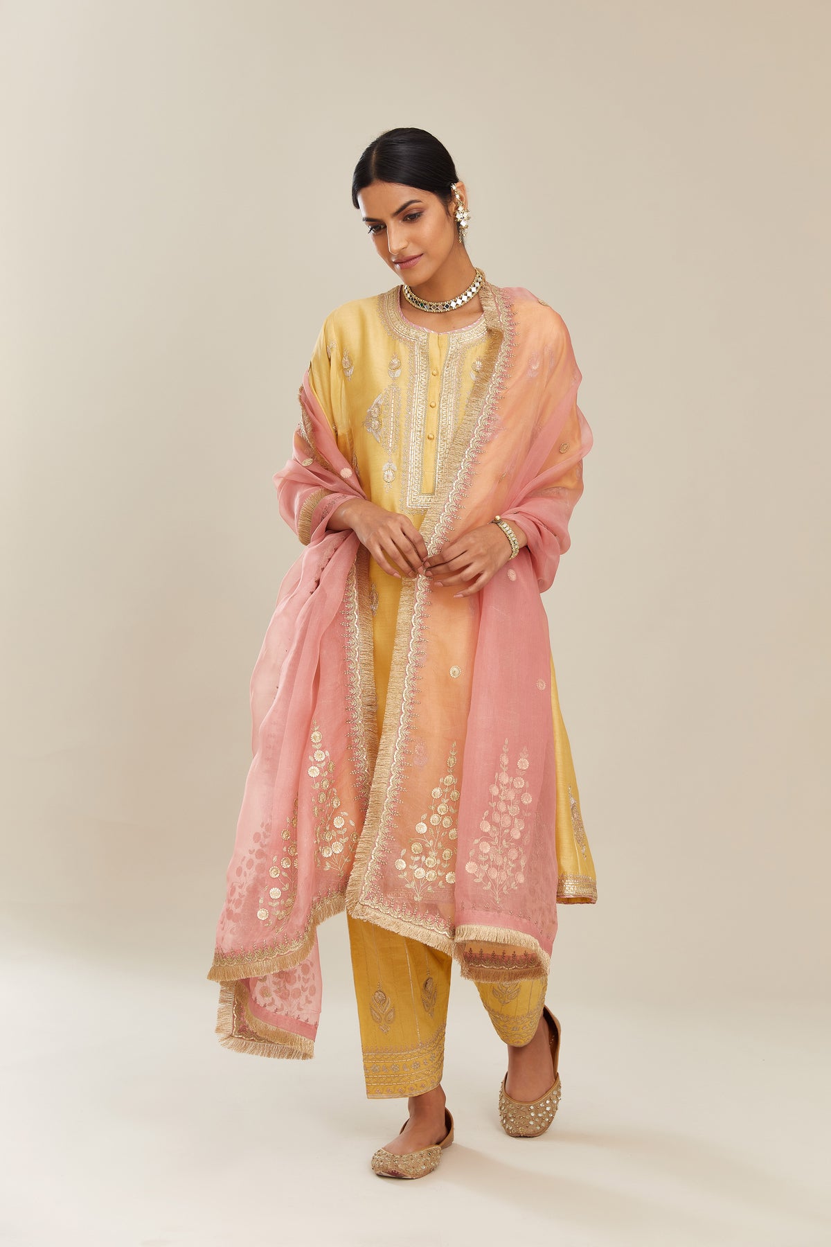 Yellow short kalidar silk chanderi kurta set with button placket and all over gold gota and zari embroidery.