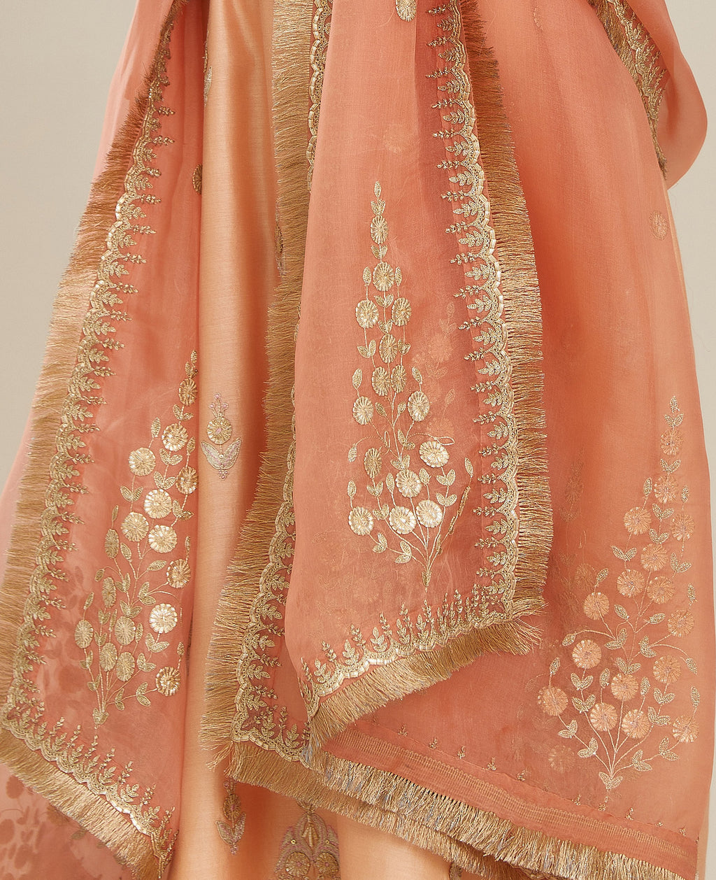Coral peach silk organza dupatta with delicate gold zari and gota embroidery border running along all edges.