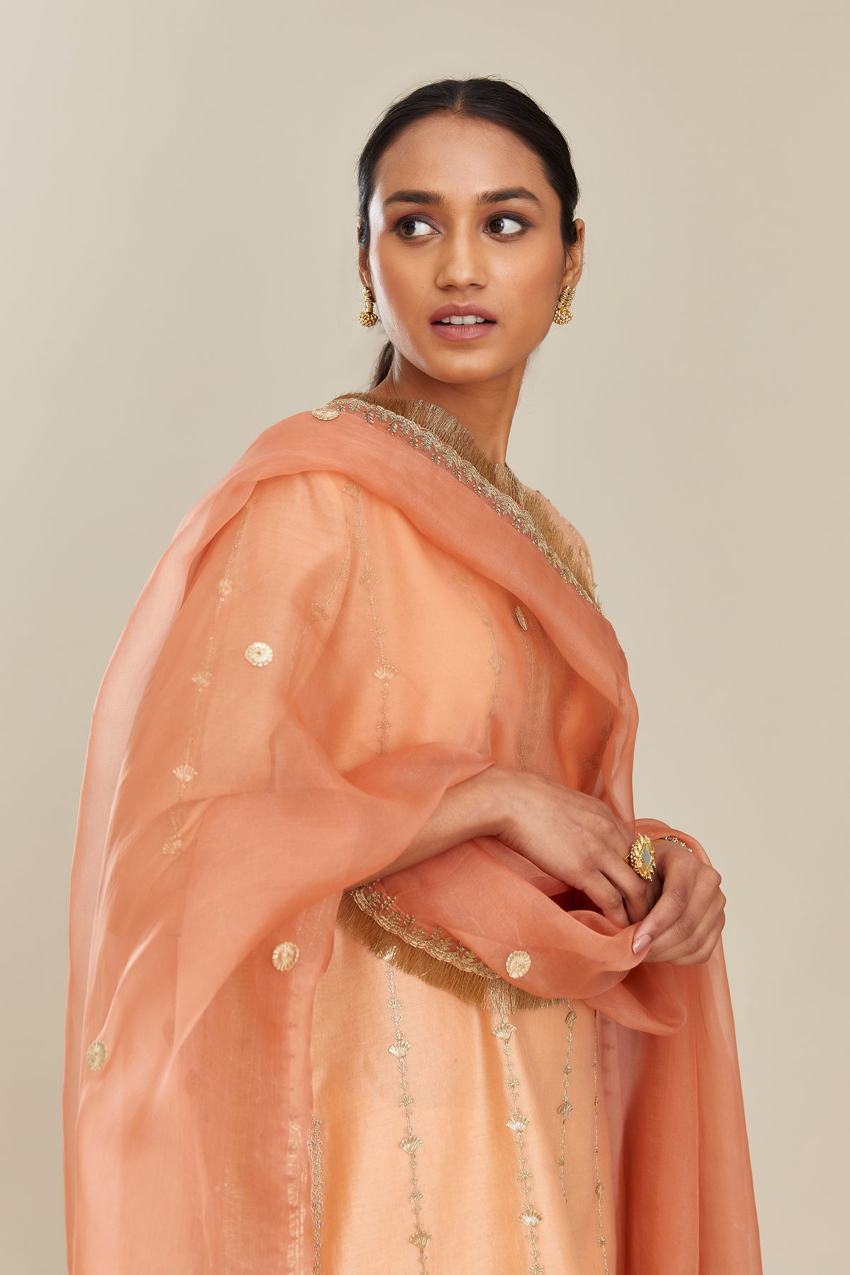 Coral peach silk organza dupatta with delicate gold zari and gota embroidery border running along all edges.
