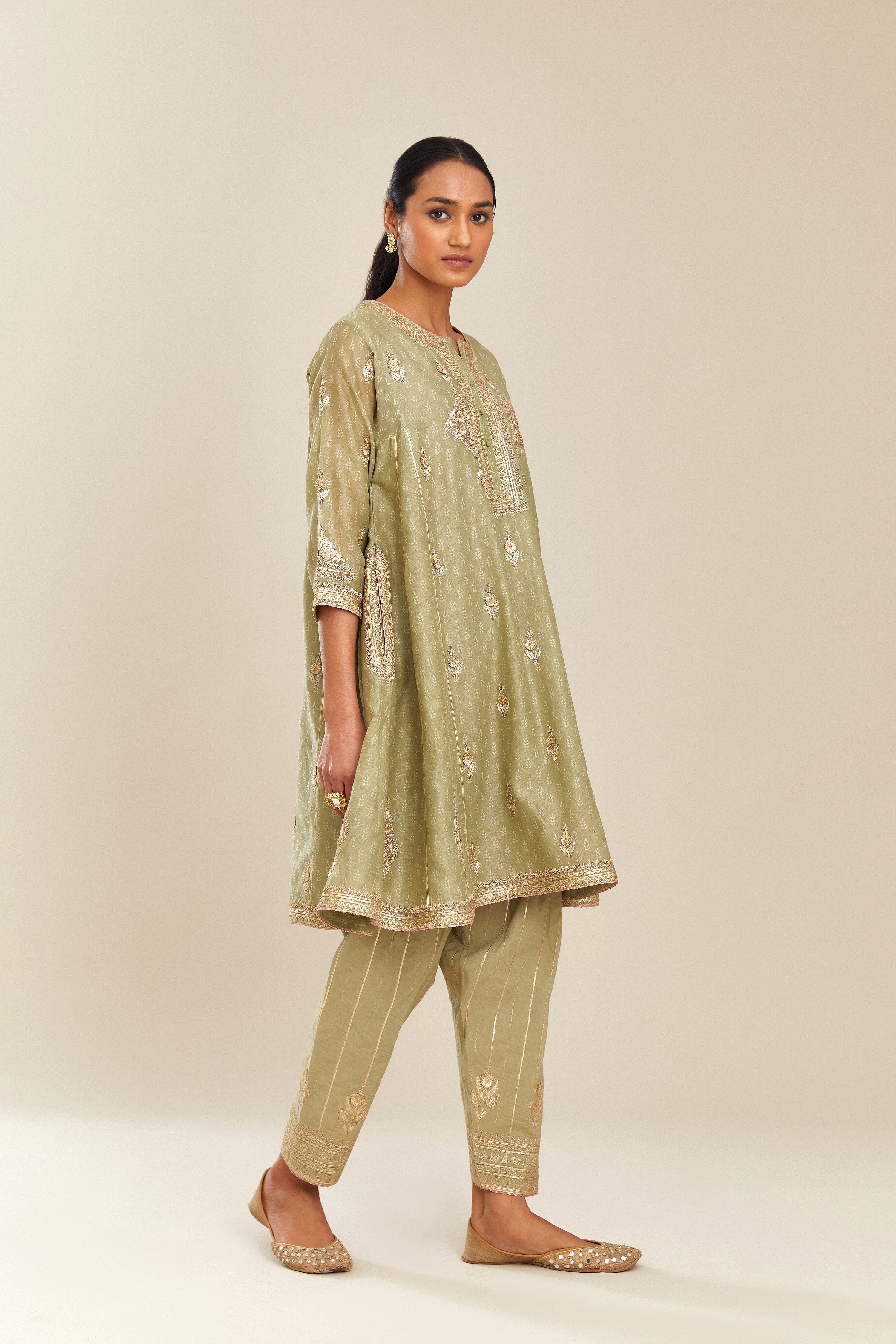 Sage green hand block printed short kalidar silk chanderi kurta set with button placket and all over gold gota and zari embroidery.