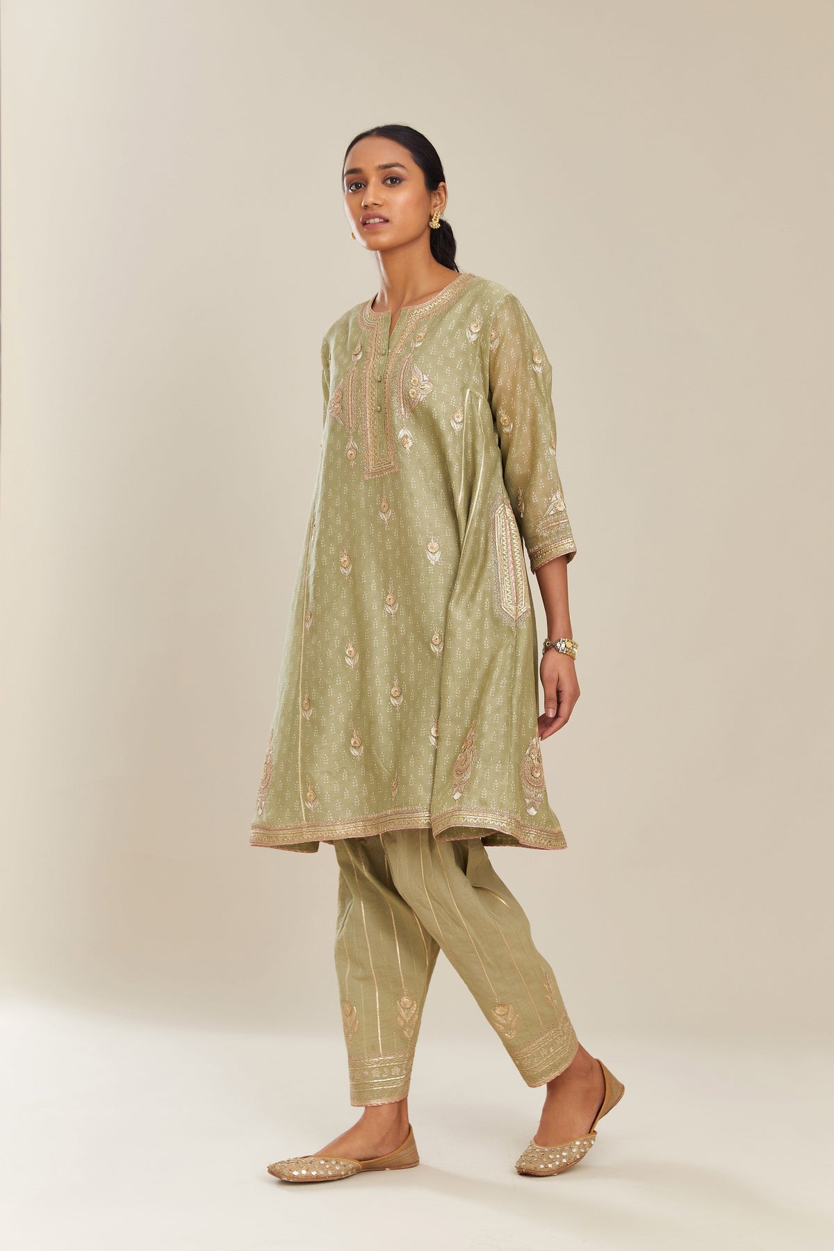 Sage green hand block printed short kalidar silk chanderi kurta set with button placket and all over gold gota and zari embroidery.