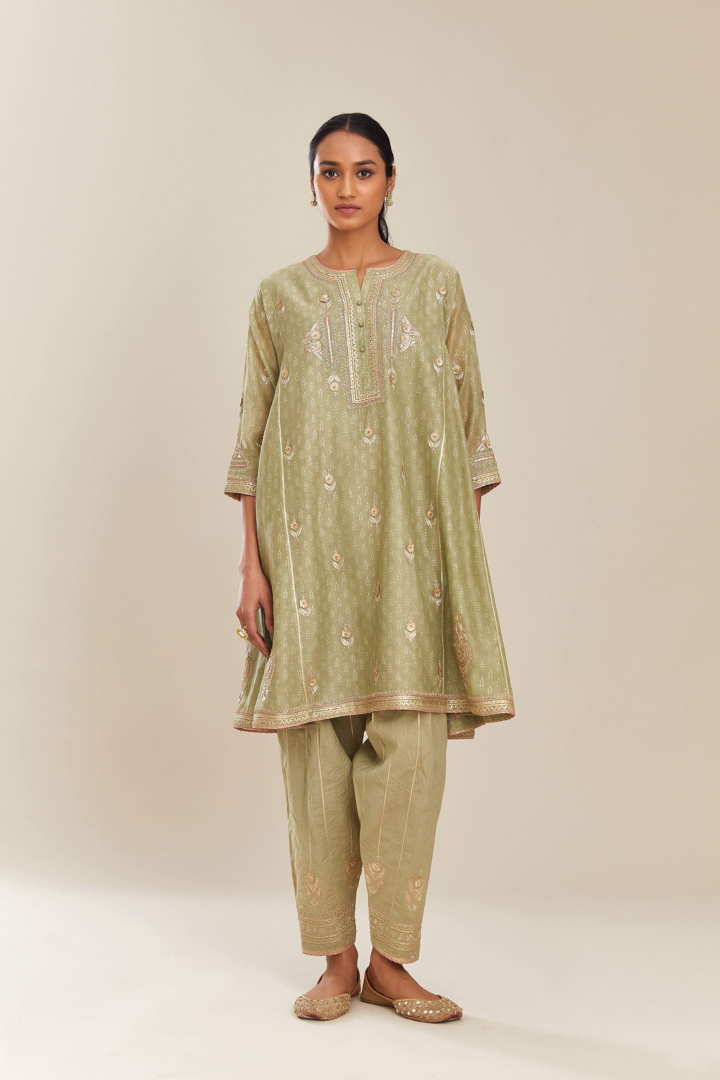 Sage green hand block printed short kalidar silk chanderi kurta set with button placket and all over gold gota and zari embroidery.