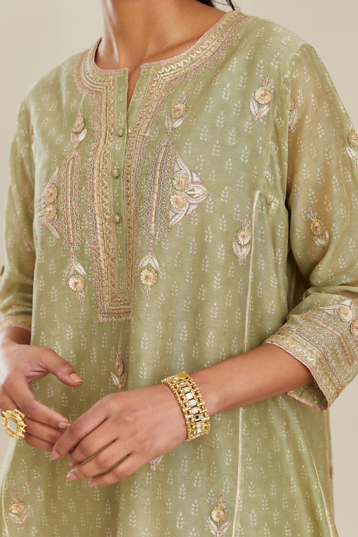 Sage green hand block printed short kalidar silk chanderi kurta set with button placket and all over gold gota and zari embroidery.