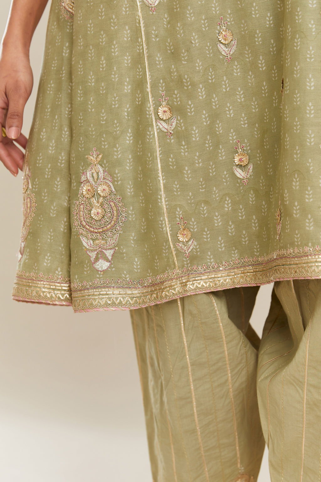 Sage green hand block printed short kalidar silk chanderi kurta set with button placket and all over gold gota and zari embroidery.