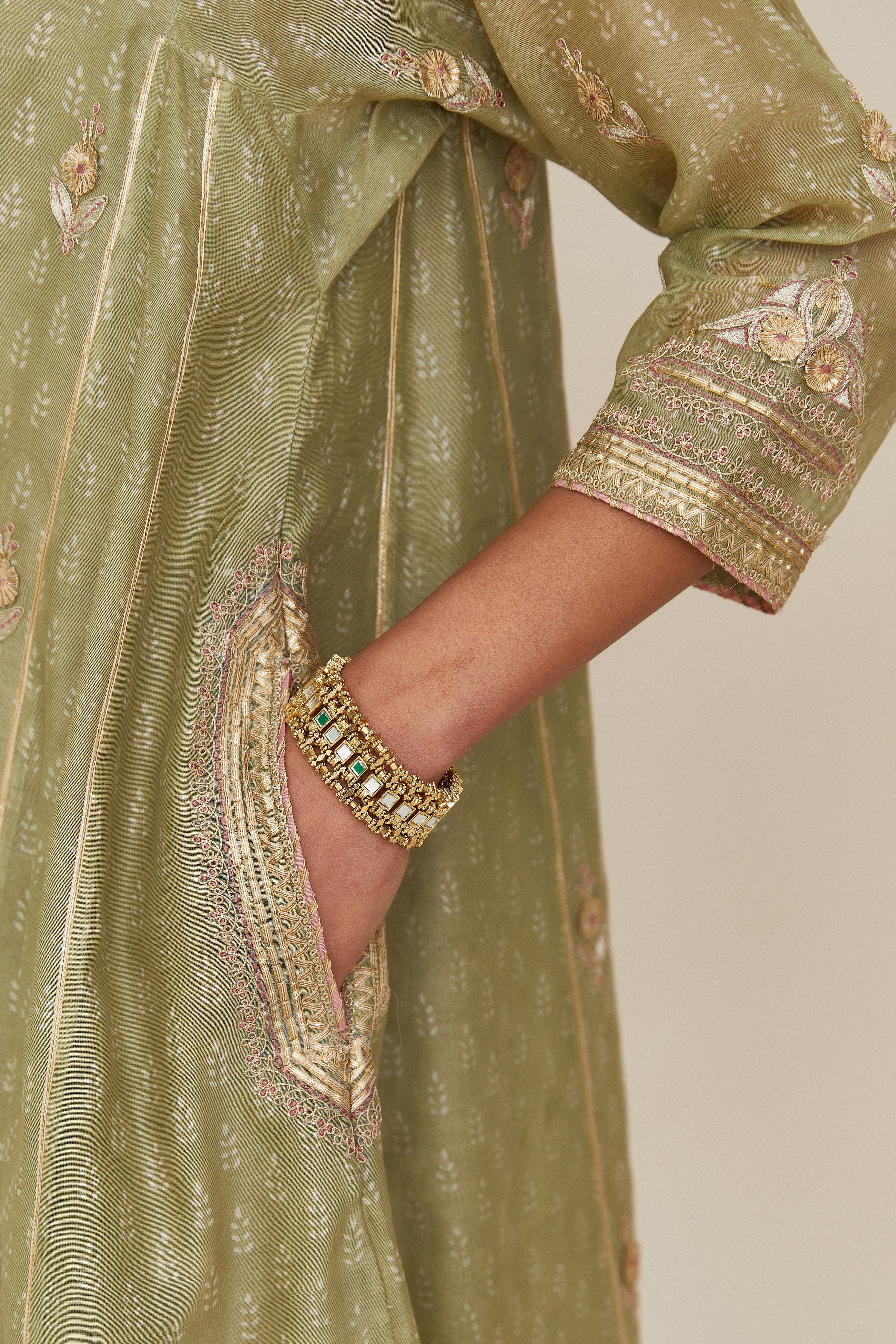 Sage green hand block printed short kalidar silk chanderi kurta set with button placket and all over gold gota and zari embroidery.