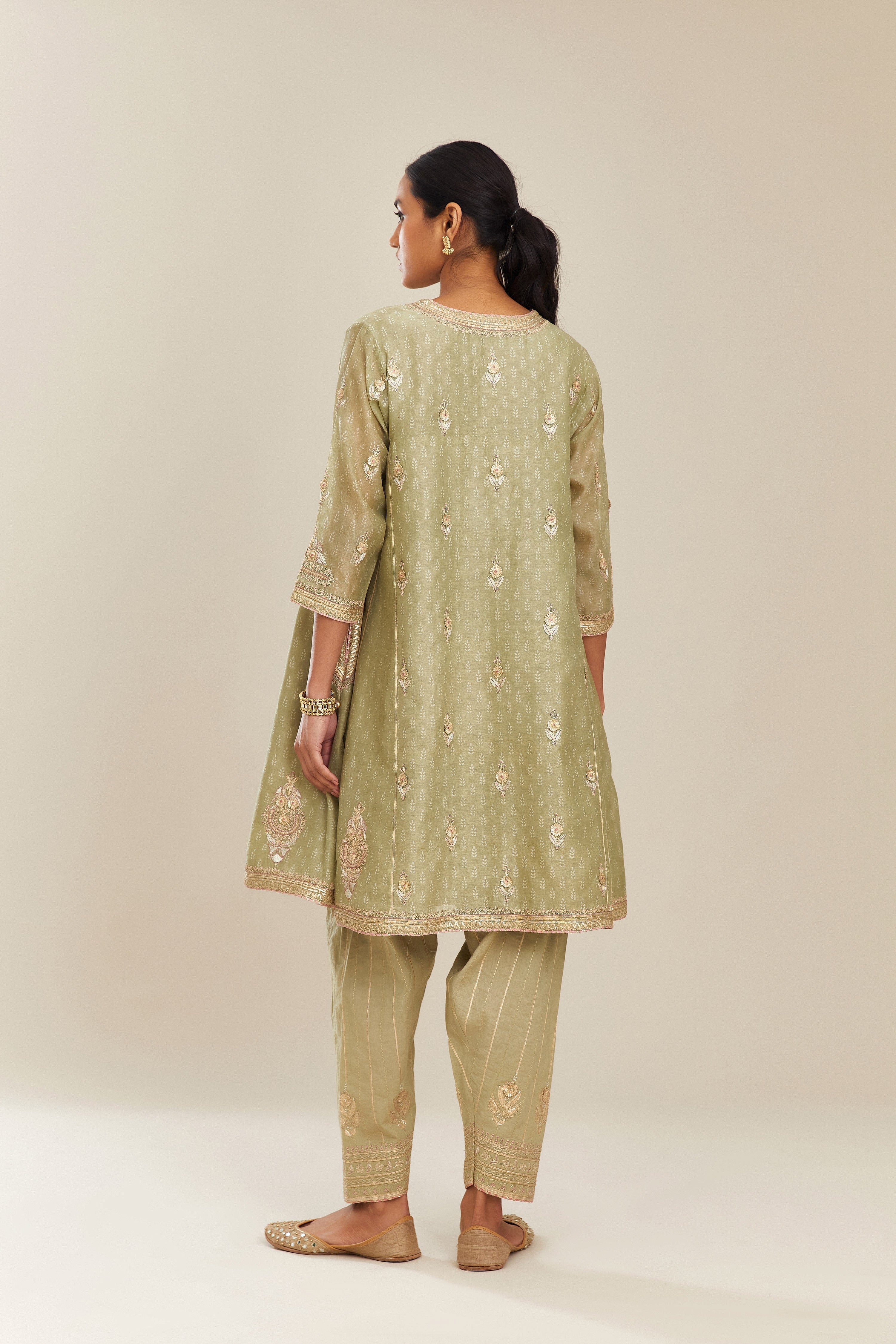 Sage green hand block printed short kalidar silk chanderi kurta set with button placket and all over gold gota and zari embroidery.
