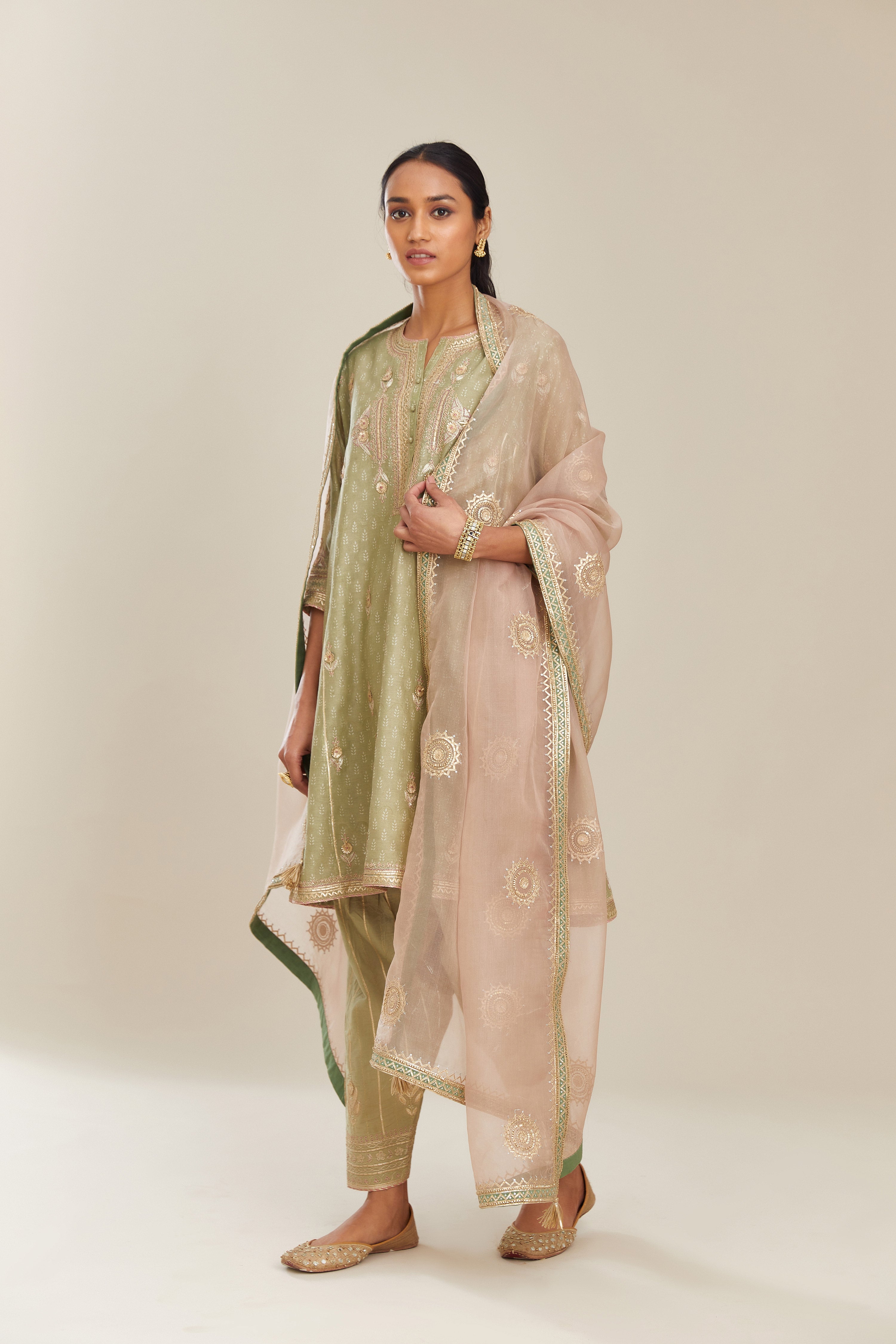Sage green hand block printed short kalidar silk chanderi kurta set with button placket and all over gold gota and zari embroidery.