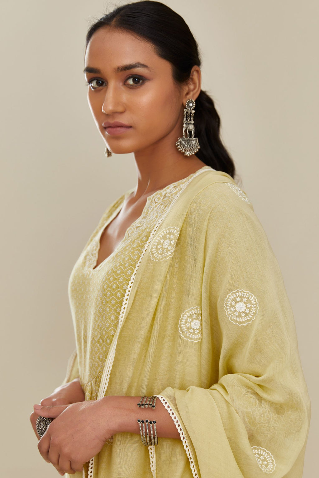 Yellow cotton chanderi dupatta with all over round booti embroidery.