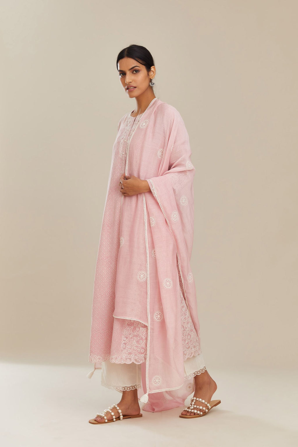 Pink hand block over-printed cotton straight kurta set with cotton chanderi cutwork embroidery highlighted with sequins.