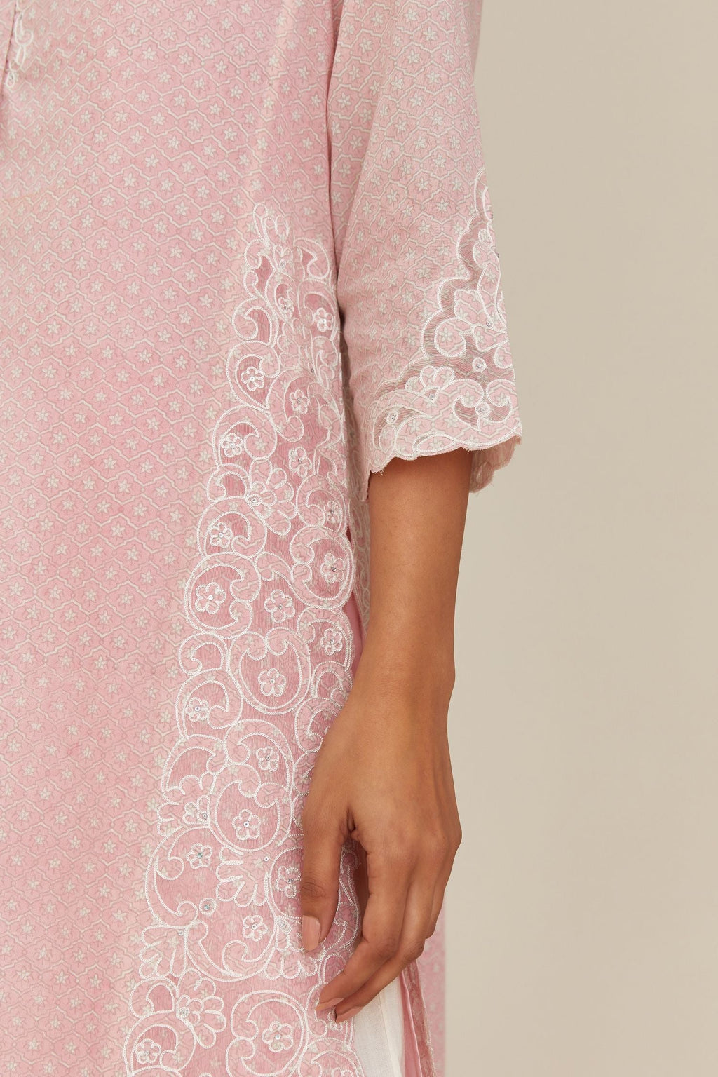 Pink hand block over-printed cotton straight kurta set with cotton chanderi cutwork embroidery highlighted with sequins.