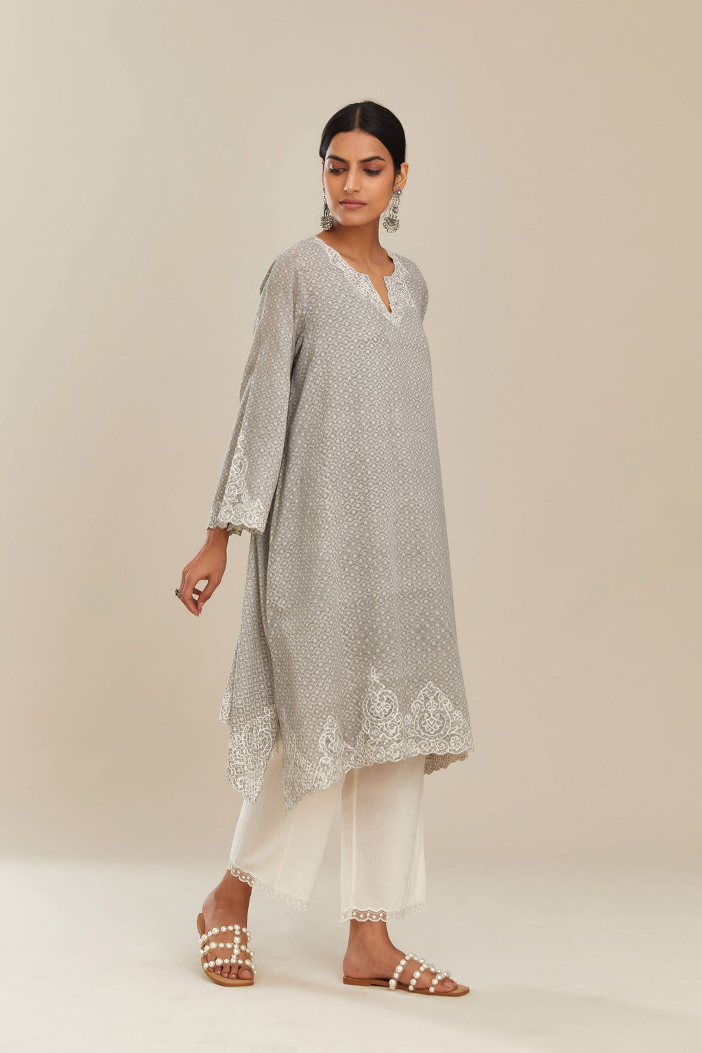 A-line hand block over-printed grey kurta set with bell sleeves and cutwork embroidery with sequins.
