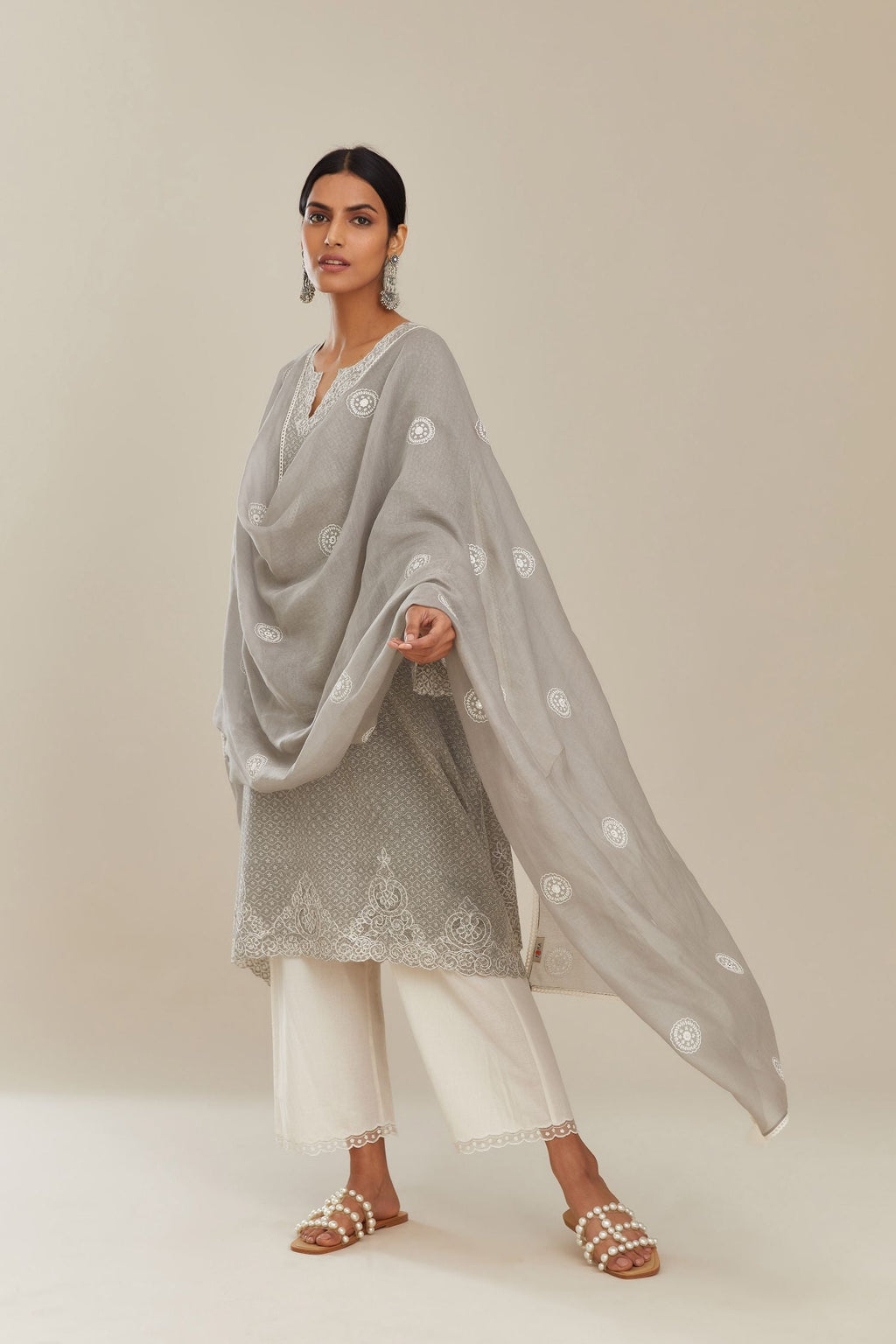 A-line hand block over-printed grey kurta set with bell sleeves and cutwork embroidery with sequins.