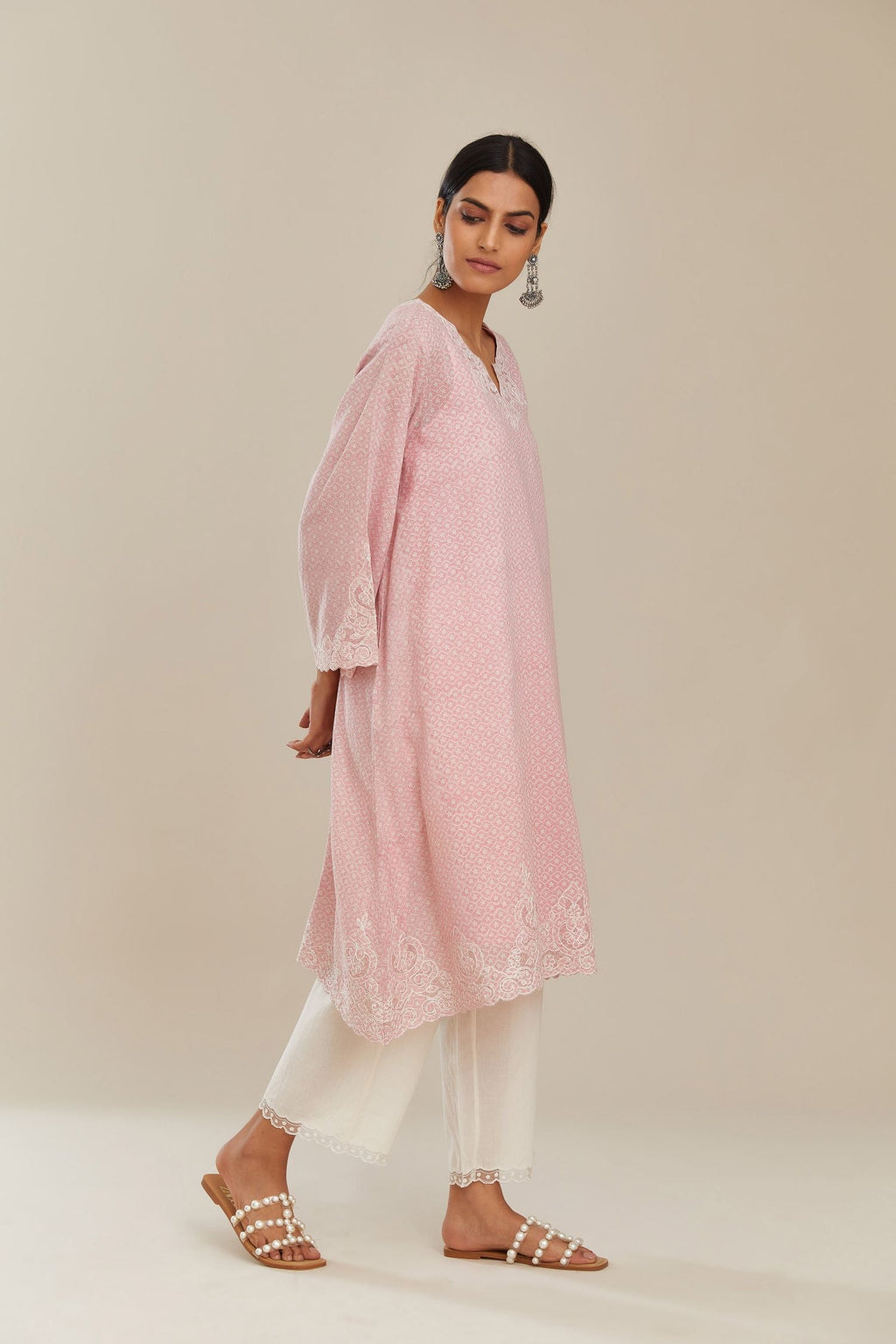 A-line hand block over-printed pink kurta set with bell sleeves and cutwork embroidery with sequins.