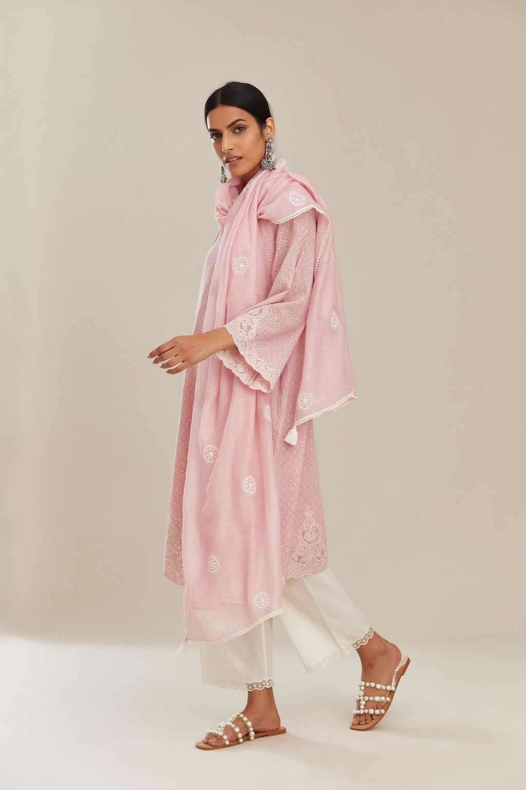 A-line hand block over-printed pink kurta set with bell sleeves and cutwork embroidery with sequins.