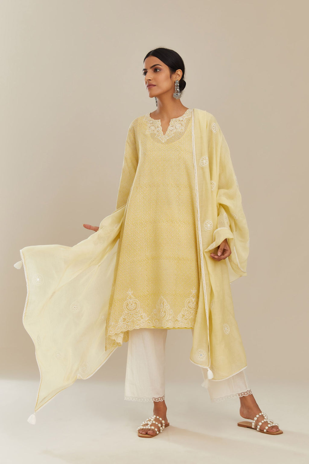 Yellow cotton chanderi dupatta with all over round booti embroidery.