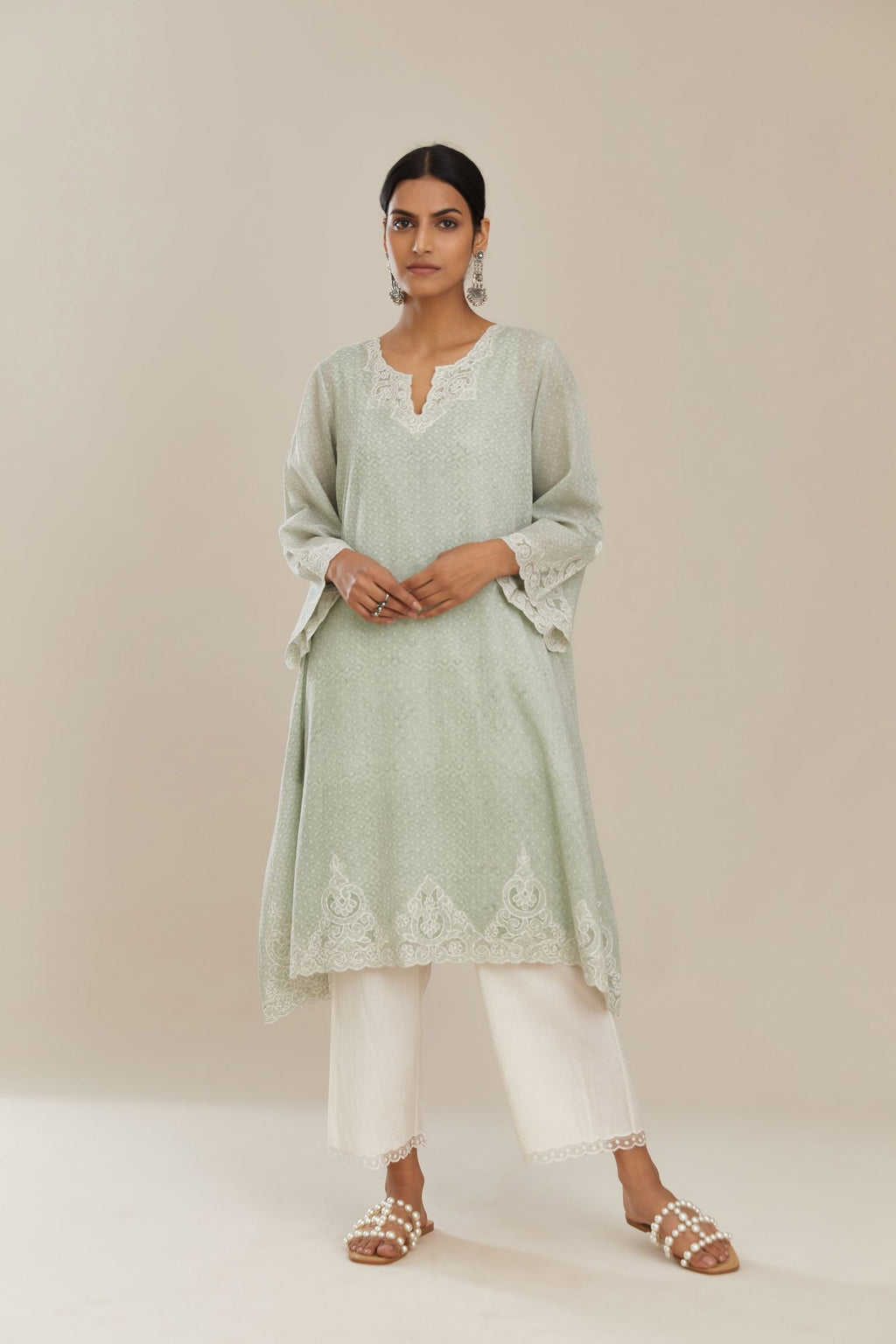 A-line hand block over-printed green kurta set with bell sleeves and cutwork embroidery with sequins.