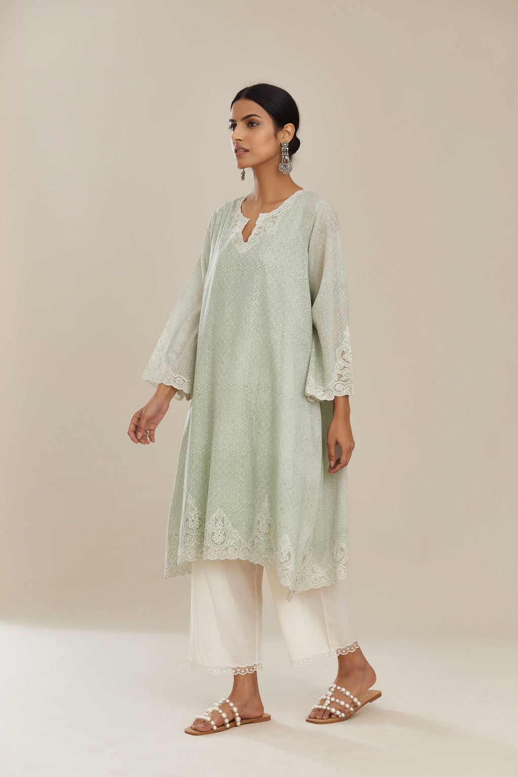 A-line hand block over-printed green kurta set with bell sleeves and cutwork embroidery with sequins.