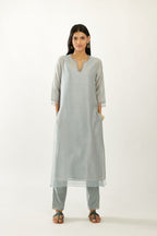 Blue silk chanderi hand block printed straight kurta set, highlighted with scalloped organza at edges.