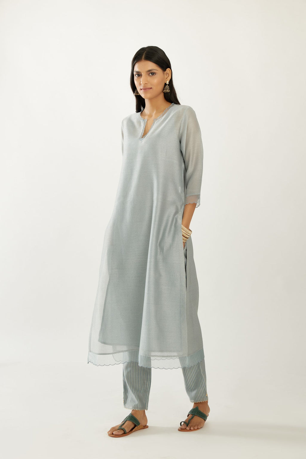 Blue silk chanderi hand block printed straight kurta set, highlighted with scalloped organza at edges.