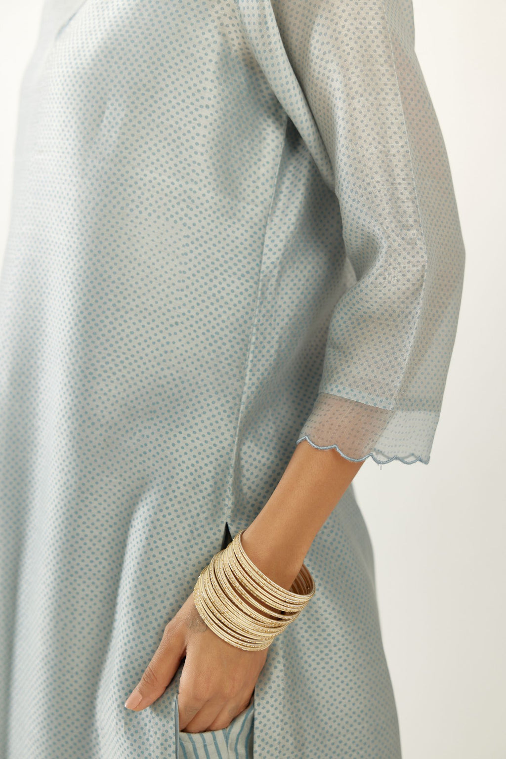 Blue silk chanderi hand block printed straight kurta set, highlighted with scalloped organza at edges.