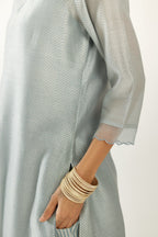 Blue silk chanderi hand block printed straight kurta set, highlighted with scalloped organza at edges.
