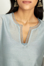 Blue silk chanderi hand block printed straight kurta set, highlighted with scalloped organza at edges.