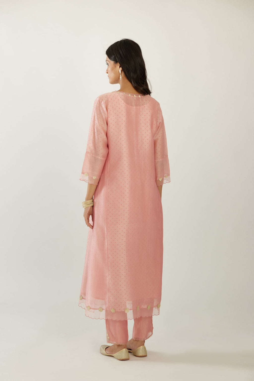 Pink hand block printed silk chanderi kurta set with concealed button placket neckline, Highlighted with gota flower and scalloped organza at edges.