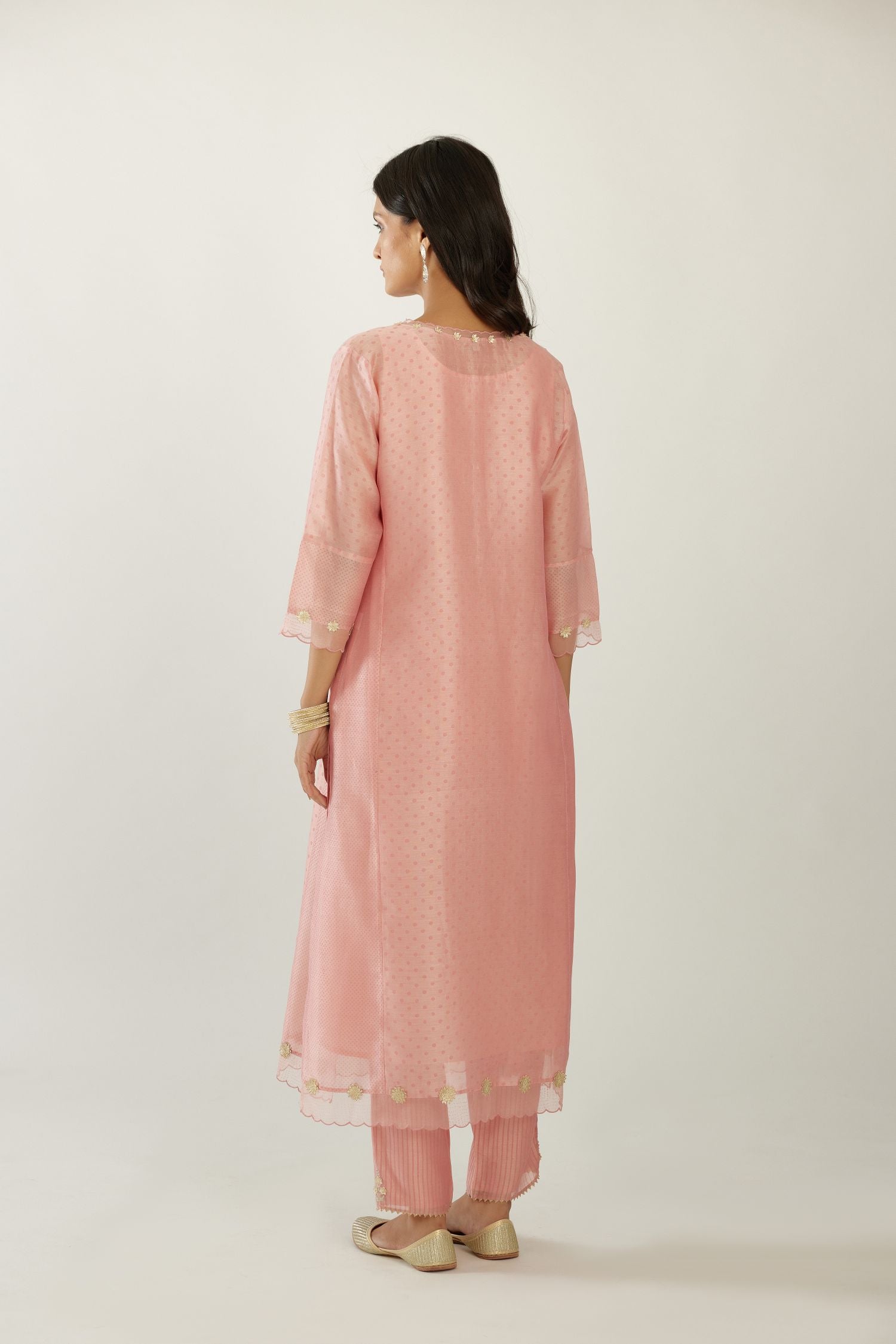Pink hand block printed silk chanderi kurta set with concealed button placket neckline, Highlighted with gota flower and scalloped organza at edges.