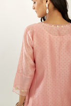 Pink hand block printed silk chanderi kurta set with concealed button placket neckline, Highlighted with gota flower and scalloped organza at edges.