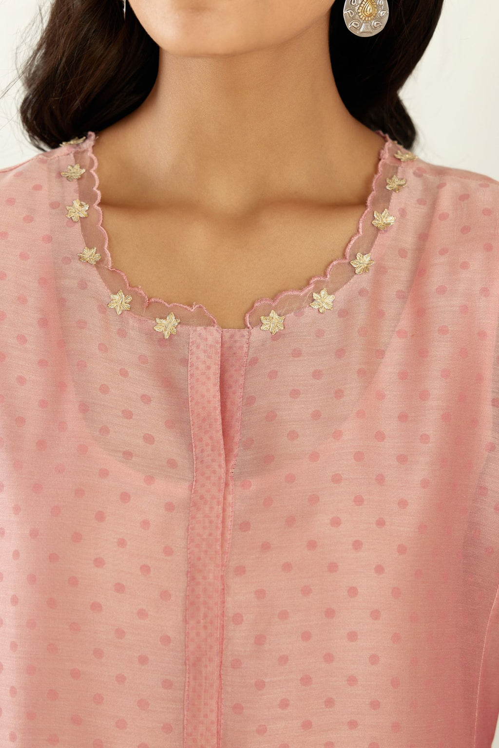 Pink hand block printed silk chanderi kurta set with concealed button placket neckline, Highlighted with gota flower and scalloped organza at edges.