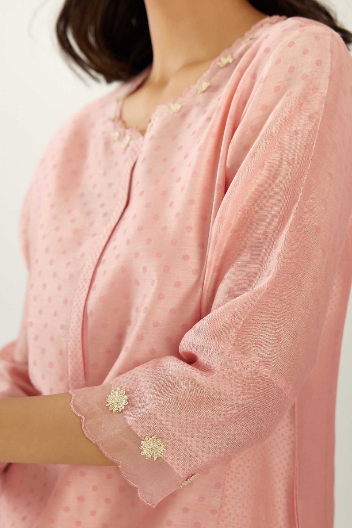 Pink hand block printed silk chanderi kurta set with concealed button placket neckline, Highlighted with gota flower and scalloped organza at edges.
