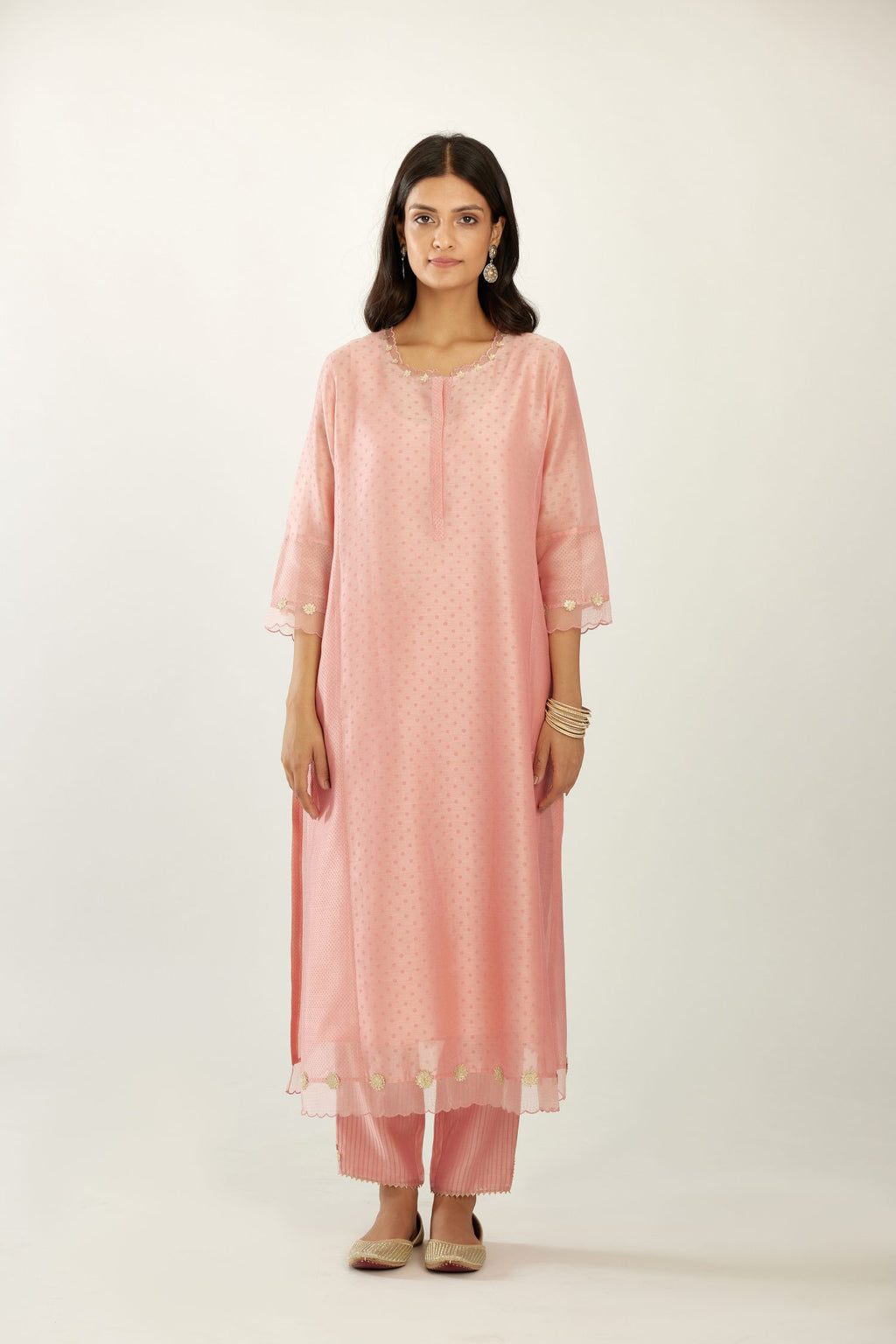 Pink hand block printed silk chanderi kurta set with concealed button placket neckline, Highlighted with gota flower and scalloped organza at edges.