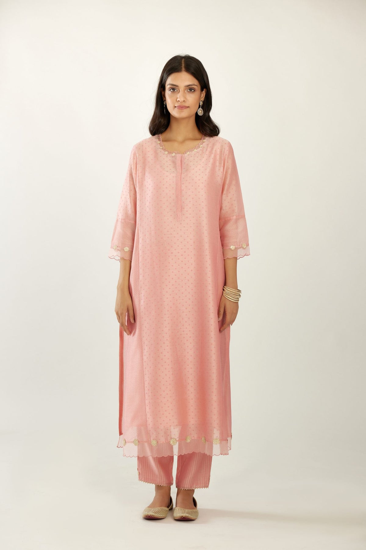Pink hand block printed silk chanderi kurta set with concealed button placket neckline, Highlighted with gota flower and scalloped organza at edges.
