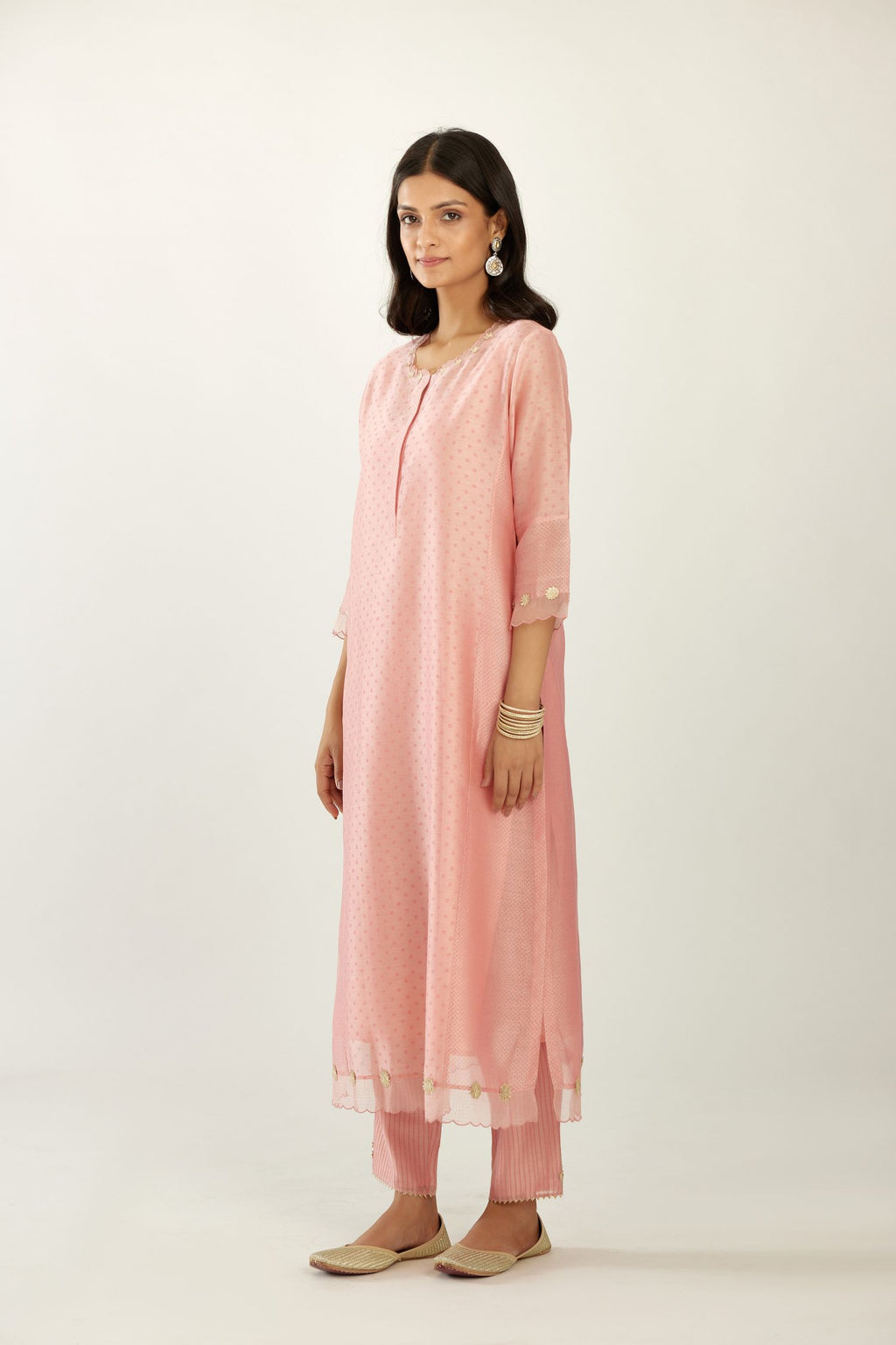 Pink hand block printed silk chanderi kurta set with concealed button placket neckline, Highlighted with gota flower and scalloped organza at edges.