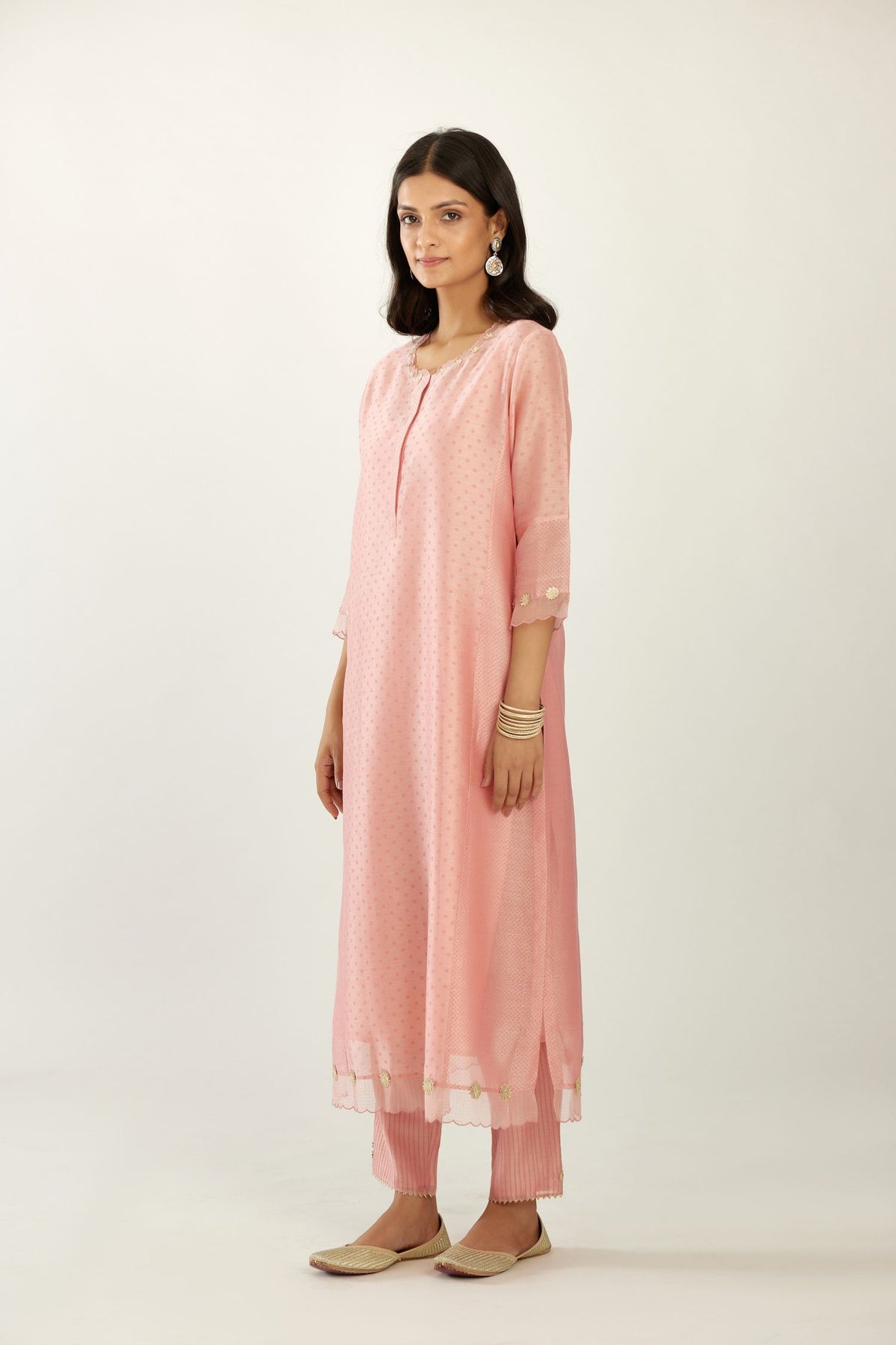 Pink hand block printed silk chanderi kurta set with concealed button placket neckline, Highlighted with gota flower and scalloped organza at edges.