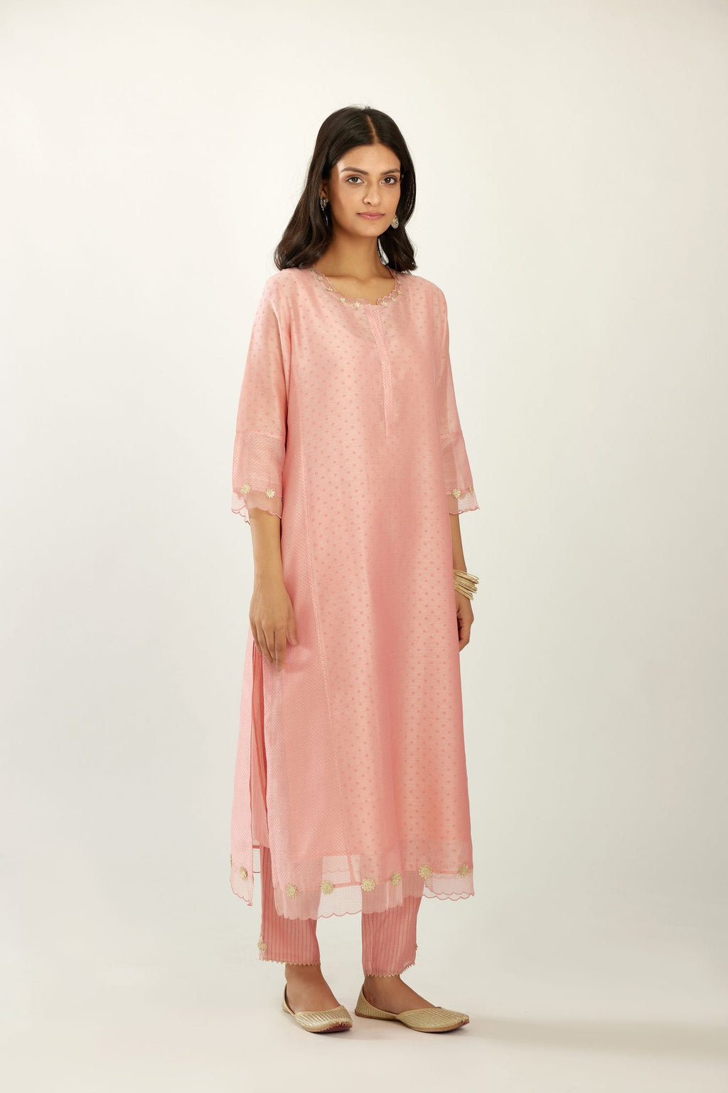 Pink hand block printed silk chanderi kurta set with concealed button placket neckline, Highlighted with gota flower and scalloped organza at edges.