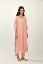 Pink hand block printed silk chanderi kurta set with concealed button placket neckline, Highlighted with gota flower and scalloped organza at edges.