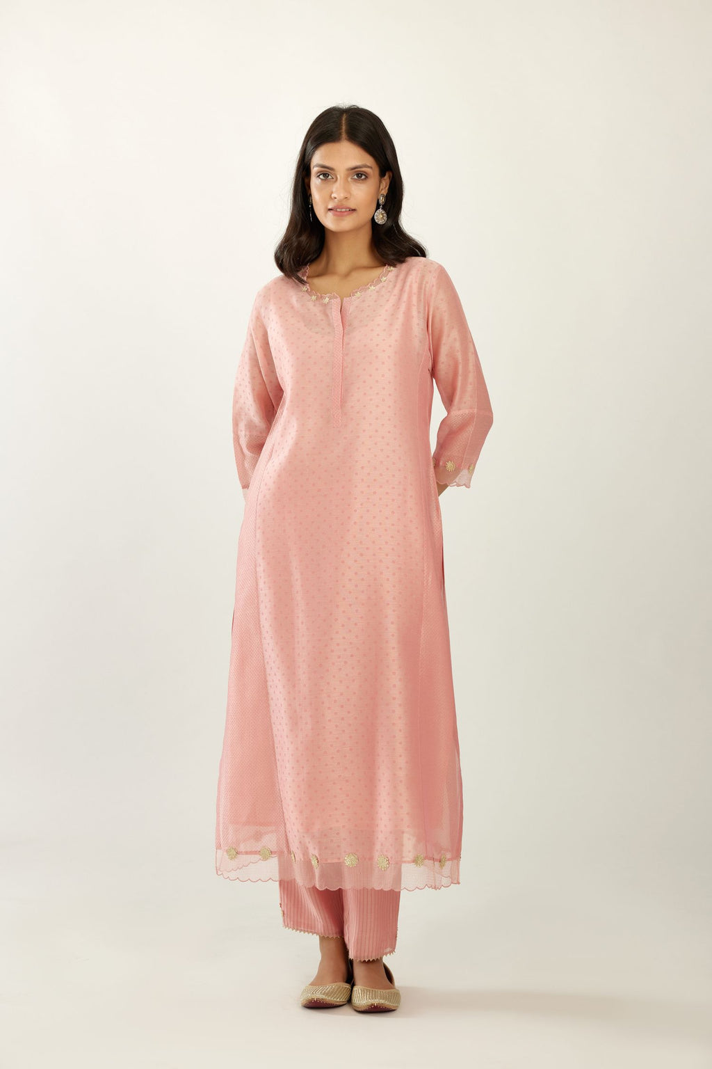 Pink hand block printed silk chanderi kurta set with concealed button placket neckline, Highlighted with gota flower and scalloped organza at edges.