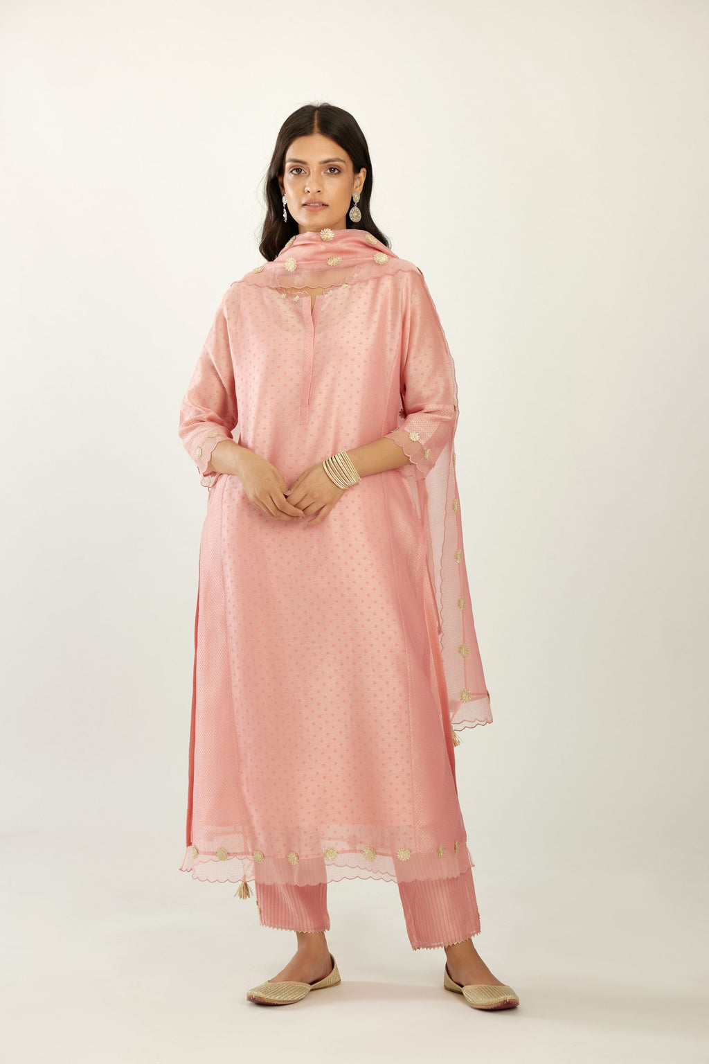 Pink hand block printed silk chanderi kurta set with concealed button placket neckline, Highlighted with gota flower and scalloped organza at edges.