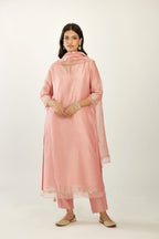 Pink hand block printed silk chanderi kurta set with concealed button placket neckline, Highlighted with gota flower and scalloped organza at edges.
